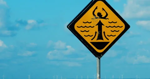 Rip Current Sign and Offshore Windmills Stock Footage 285458330
