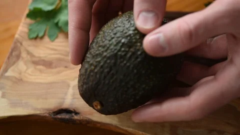 Ripe Avocado In Hands Video stock 104787438