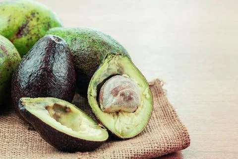 Ripe avocado on sack. Stock Photos