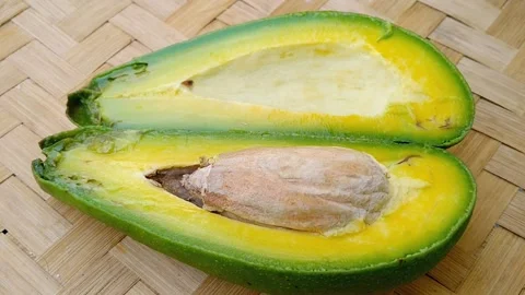 Ripe Avocado Split Open On Bamboo Mat Video stock 341907442