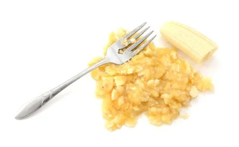 Ripe banana being mashed with a fork Foto stock