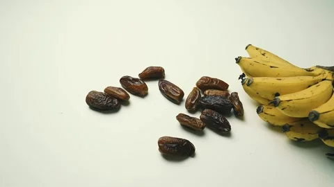Ripe Bananas and Dried Dates on White Surface Footage, A bunch of ripe bana.. Vídeos de archivo 304975064