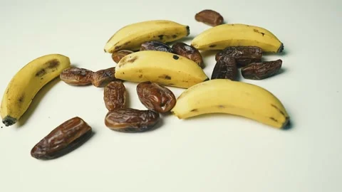 Ripe Bananas and Dried Dates on White Surface, A collection of ripe bananas.. Vídeos de archivo 304977491