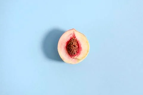 Ripe beautiful peach split in half. Visible the stone is Stock Photos