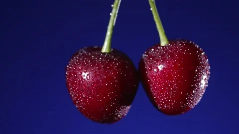 Ripe cherries on a blue background Video stock 157682020