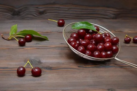 Ripe cherries in a colander Stock Photos
