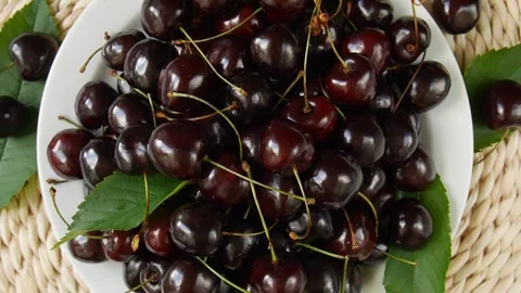 Ripe cherries on a plate. Video stock 302053186