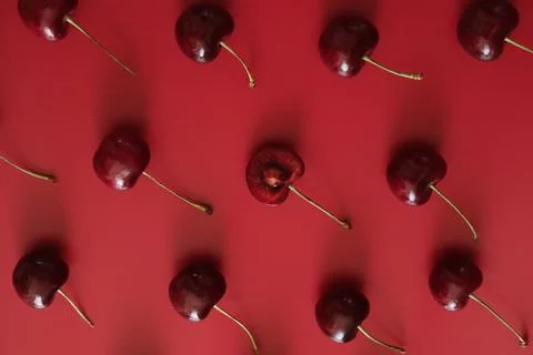 Ripe cherries on red background 写真素材