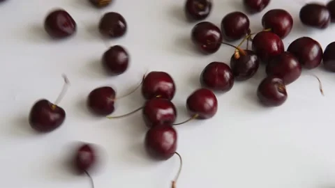 Ripe cherries rolling on the surface of the table. Stock Footage 163400405