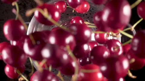 The ripe cherry falls down into a colander slow motion Stock Footage 90487877