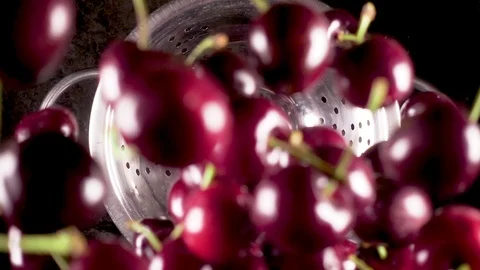 The ripe cherry falls down into a colander slow motion Stock Footage 90487989