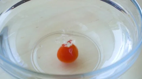 Ripe cherry tomatoes fall into a bowl of water slow motion Stock Footage 90493726