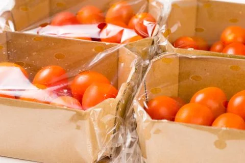 Ripe cherry tomatoes packages in box and plastic Stock Photos