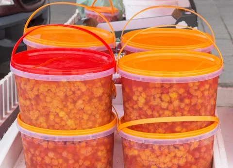 Ripe cloudberry in plastic buckets Stock-Fotos