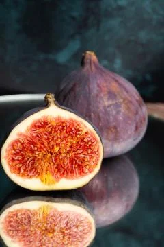 Ripe figs in a section on a glass table. Stock Photos