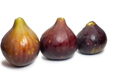 Ripe figs on a white background. Several figs. Southern fruit isolate. Purple Stock Photos