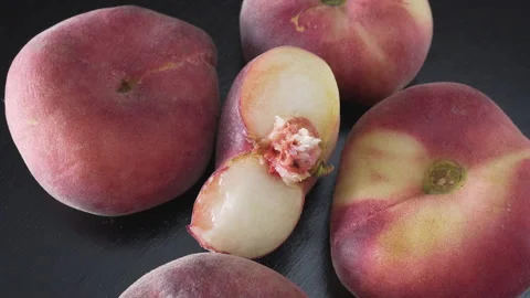Ripe flat peaches on a black background close up Stock Footage 137441896