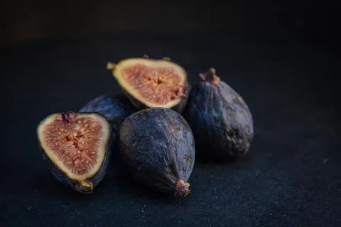 Ripe fresh figs on dark background Stock Photos