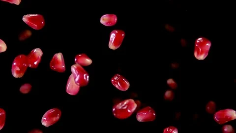 Ripe garnet grains fly to the camera Stock Footage 73858627