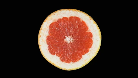 Ripe grapefruit in the section slowly rotates around its axis. Isolated on a whi Stock Footage 119686383