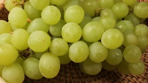 Ripe green grapes rotating in a wicker basket Stock Footage 342437520