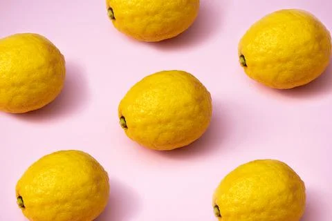 Ripe lemons pattern. Set of yellow lemons on bright pink background Stock Photos