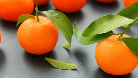 Ripe mandarin with leaves on a table Stock Footage 70453402