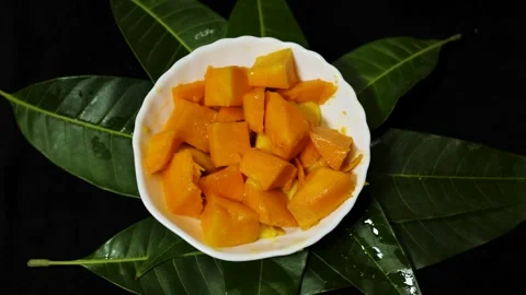 Ripe mango cubes arranged in decorative hedgehog style in bowl with vibrant.. Stock Footage 336646229