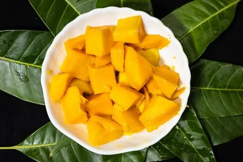 Ripe mango cubes arranged in decorative hedgehog style in bowl with vibrant.. Stock Photos