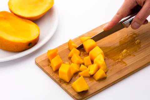 Ripe mango fruit pulp diced with a kitchen knife Stock Photos