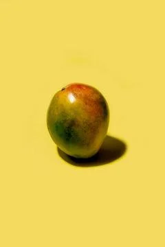 Ripe mango on a solid yellow background Stock Photos