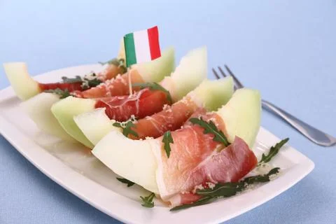 Ripe melon slice with ham, parmesan, italy flag Stock Photos