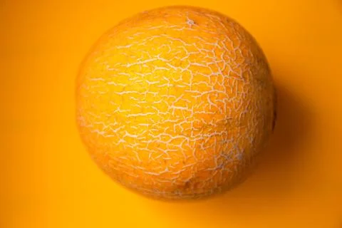 Ripe melon on a yellow background. Top view, flat lay Stock Photos