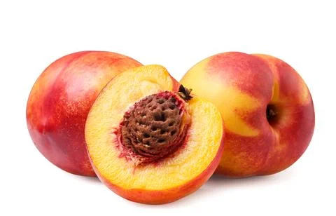 Ripe nectarines and a half close-up on a white background. Stock Photos