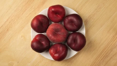 Ripe nectarines and peaches rotating on a plate Stock Footage 344604553