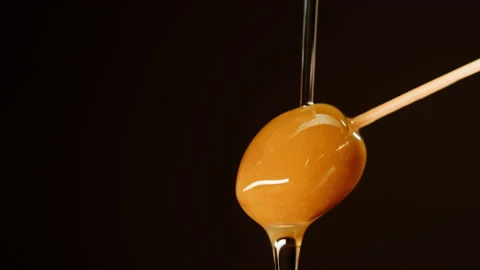 Ripe olive on black background close-up. Falling olive oil drops. Stock Footage 195124028