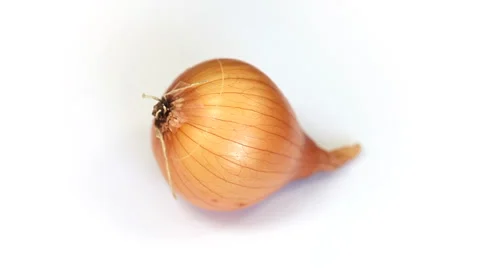 Ripe onion rotating on a white background Stock Footage 35569054