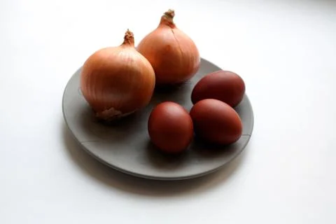 Ripe onions and brown colored eggs Stock Photos