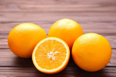 Ripe orange fruit on a brown background Stock Photos