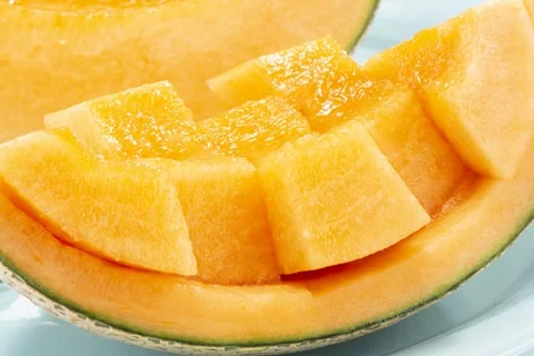 Ripe Orange Melon Cut Into Bite Sized Cubes on the Rind Stock Footage 336833973