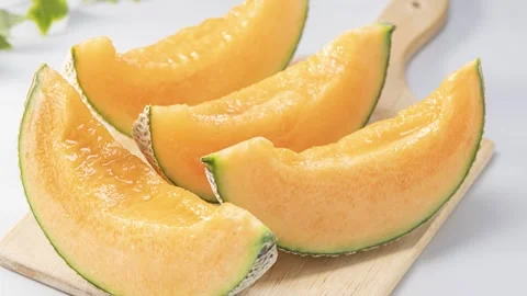 Ripe Orange Melon Cut Into Bite Sized Cubes on the Rind Stock Footage 337592501
