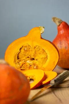 Ripe orange pumpkins in the kitchen on the table, the holiday is very much Stock Photos