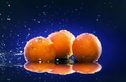 Ripe oranges on mirror Stock Photos