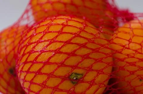 Ripe oranges in the net Stock Photos