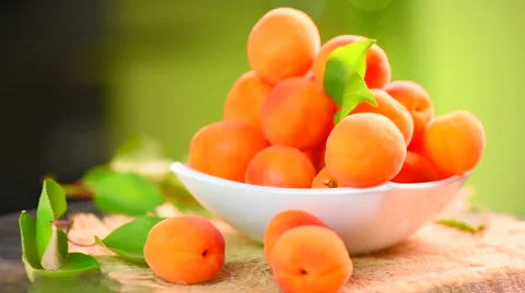 Ripe organic apricots with leaves on wooden table Stock Footage 59081288