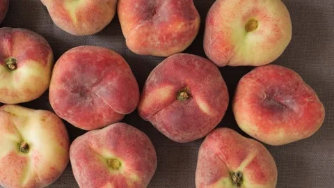 Ripe organic flat peaches moving slowly Stock Footage 337885791