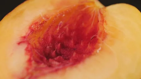 Ripe peach in a cut on a dark background close up Stock Footage 165991550