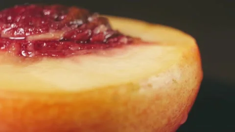 Ripe peach in a cut on a dark background close up Stock Footage 167213791