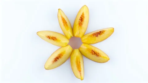 Ripe peach fruit sections. Top view from above of peach slices forming a star Stock Footage 93984790