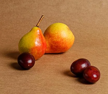 Ripe pears on a brown background Stock Photos